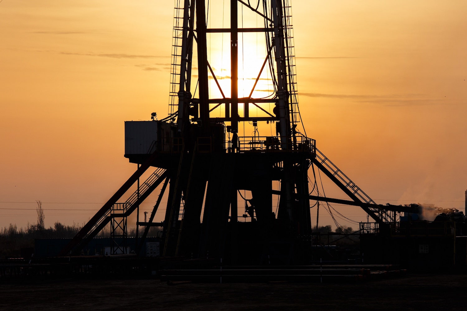 Oil Rig at Sunset with Workers